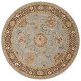 Close-up of round Nourison 2000 Blue Persian rug. Light blue field with brown floral pattern and border. Handmade wool rug.