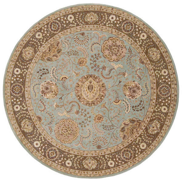 Close-up of round Nourison 2000 Blue Persian rug. Light blue field with brown floral pattern and border. Handmade wool rug.