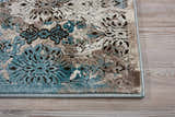 Close-up of Nourison Karma Ivory/Blue Vintage Rug showing floral pattern and texture. Chestnut, ivory, and blue tones.