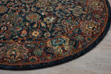 Close up of round Nourison 2020 Navy rug showing traditional floral pattern in navy, rust, gold, and teal.