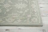 Close-up of the Nourison Zephyr Light Taupe rug showing floral pattern and wool texture on a light wood floor.