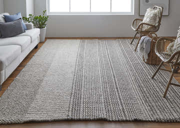 Living room scene with a Feizy Hamden Ivory/Brown rug, white sofa, and rattan chairs for a modern, Scandinavian look. Roomscene-Rectangle