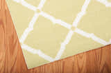 Close-up of the Nourison Home & Garden Light Green rug. Features a white geometric trellis pattern.