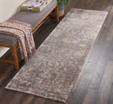 Entryway with Nourison Lucent Flint vintage runner rug on dark wood floor, styled with bench and throw.