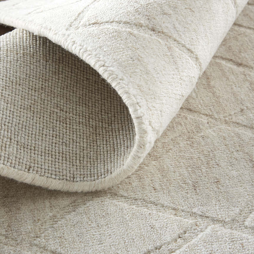 Close-up of the hand-woven Feizy Redford Ivory/Gray Area Rug showing wool texture and subtle geometric pattern. Fold