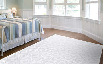 Light, airy bedroom with a Feizy Saphir Mira rug. White geometric diamond pattern complements the room's soft, neutral tones. Roomscene-Rectangle