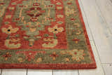 Close up of the rust-colored Nourison Tahoe rug showing the traditional floral pattern and wool texture.
