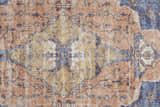 Close-up of the Feizy Percy rug. Medallion design in red, tan, and blue hues. Transitional style with distressed texture. Texture