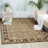 Living room scene with a grey Nourison Ararat Persian rug, neutral armchair, and light wood floors.
