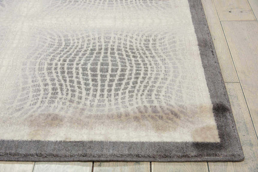 Close up of the Nourison Utopia Shell rug, showcasing its shell color and mid-century modern grid pattern.