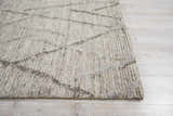 Close-up of the handmade Nourison OCEAN Stone rug; sandstone color, mid-century modern style, textured design.