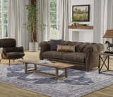 Living room scene with a Feizy Percy Gray/Ivory/Taupe rug, brown sofa, wood coffee table, and farmhouse decor. Roomscene-Rectangle