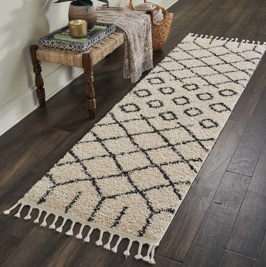 Hallway scene with Nourison Moroccan Shag Cream Tribal rug runner on dark wood floor, styled with a bench and decorative items.