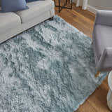 Living room scene with a Feizy Indochine blue and silver rug, light gray sofa and chair on a wood floor. Roomscene-Rectangle