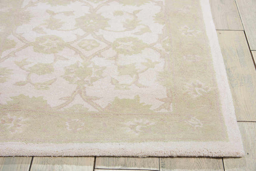 Close-up of Nourison Zephyr Ivory/Green rug showing floral pattern, soft texture, and neutral colors on wood floor.