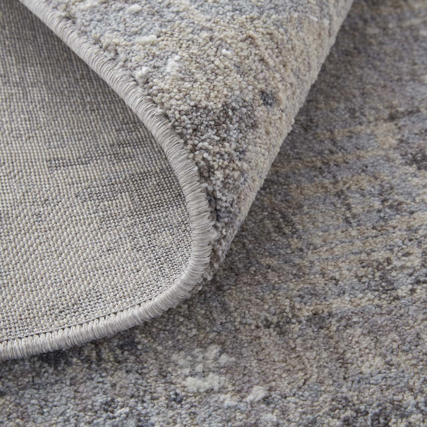 Close-up of Feizy Lennon Taupe/Tan/Blue Area Rug showing abstract pattern and soft, textured pile. Fold
