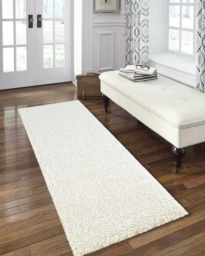 Entryway with Nourison Malibu Shag Ivory Runner Rug, white bench, wood floors, and natural light.