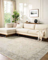 Living room with beige sectional sofa and the Vintage Edit Rachel Zoe x LIVABLISS RZVE-2304 area rug in beige, cream, and gray. Roomscene-Rectangle