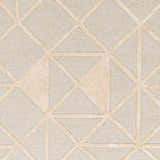 Close-up of the Botiu Blue Geometric Hand Tufted Wool Area Rug, featuring a light gray and pale peach geometric pattern. Swatch