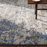 Close-up of Satsop Rock Pattern Thick Rug in a living room with a wood side table and a neutral rock pattern. Styleshot