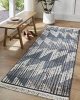 Entryway with Zaim Area Rug runner. Geometric blue and white design, wood bench, and modern decor. Roomscene-Runner