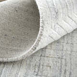 Close-up of the Feizy Redford Silver Gray rug showing the wool and viscose texture and hand woven construction. Fold