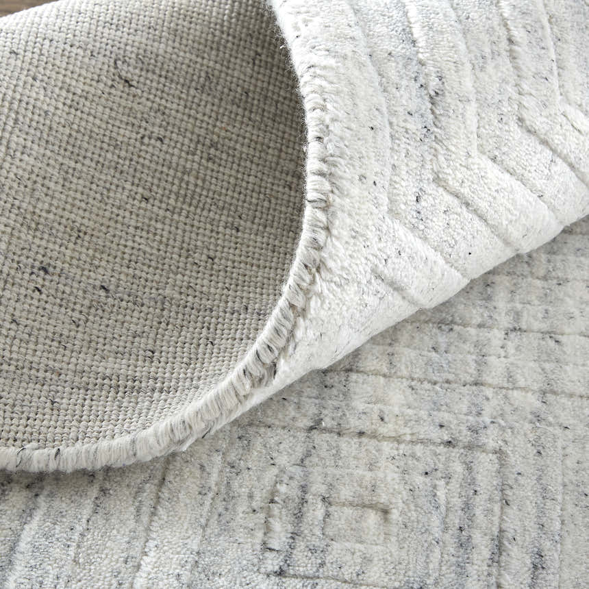 Close-up of the Feizy Redford Silver Gray rug showing the wool and viscose texture and hand woven construction. Fold