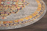 Close-up of Nourison Passionate Grey Bohemian rug, round shape. Features gray, gold, pink, and blue bohemian-inspired design.