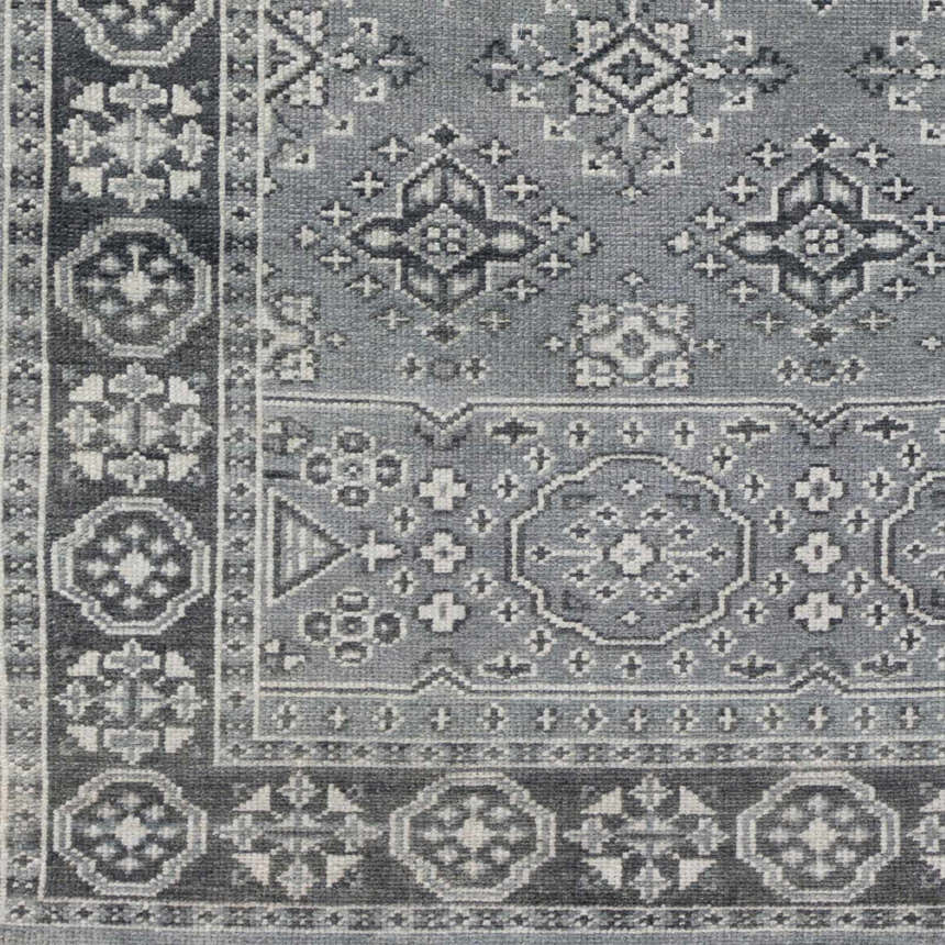 Close-up of the hand-knotted Sherwood Area Rug. Ice blue, ink blue, and teal wool with traditional Oriental patterns. Swatch