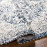 Close-up of the Shotts Thick Luxe Rug in denim and cream, showing its soft texture and traditional pattern. Fold
