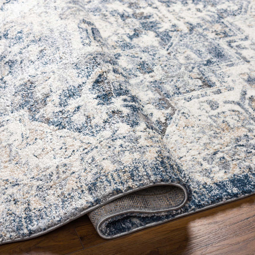 Close-up of the Shotts Thick Luxe Rug in denim and cream, showing its soft texture and traditional pattern. Fold
