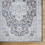 Close-up of the Hayfa Area Rug featuring a traditional gray, light blue, and gold floral pattern on a wood floor. Corner