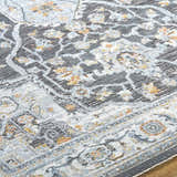 Close-up of the gray Hayfa Area Rug, a machine-woven rug with traditional floral patterns and a soft, textured pile. Texture