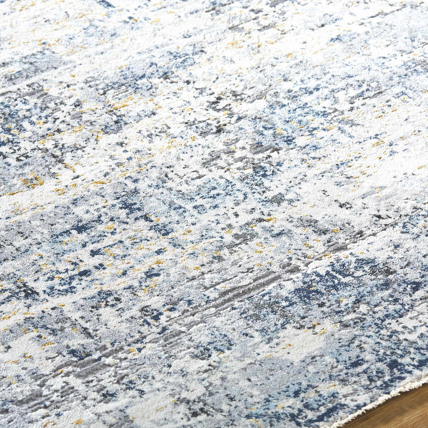 Close-up of the Hyman Area Rug showing its contemporary design with camel, gray, and denim colors. Texture