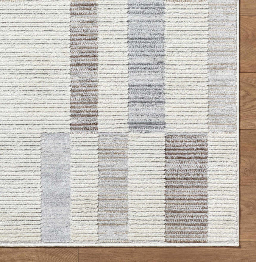 Close-up of Chouko Broken-Striped Area Rug with beige, brown, and silver gray stripes and a textured, machine-woven design. Corner