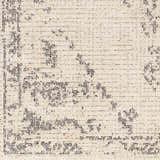 Close-up of the Tait Area Rug, featuring a bone background with a dark gray traditional pattern and subtle texture. Swatch