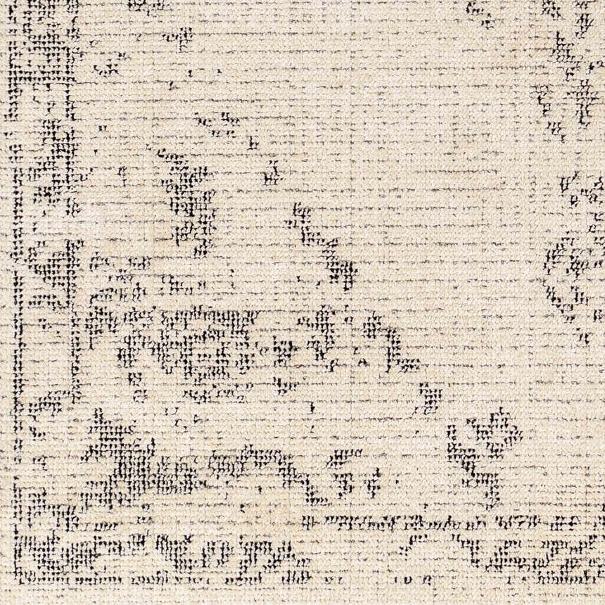 Close-up of the Tait Area Rug, featuring a bone background with a dark gray traditional pattern and subtle texture. Swatch