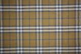 Close-up of Feizy Crosby Transitional Plaid Area Rug. Gold, blue, and white plaid pattern. Hand woven polyester rug. Texture