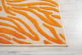 Close-up of the Nourison Aloha Orange rug, showing a contemporary burnt orange tiger-stripe design and woven texture.