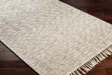 Close-up of the hand woven Amiel Beige Area Rug showing texture, fringe, and colors of clay, gray, khaki, and walnut. Corner