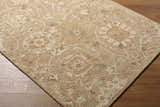 Close-up of the Lanune Traditional Handmade Area Rug showing its beige, ivory, and sandstone floral pattern and wool texture. Corner