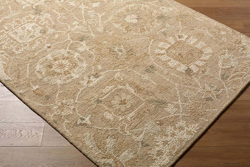 Close-up of the Lanune Traditional Handmade Area Rug showing its beige, ivory, and sandstone floral pattern and wool texture. Corner