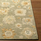 Close-up of the hand-tufted Rihuce Traditional Handmade Area Rug. Cream, pale pink, sage, and sky blue floral pattern. 100% wool. Front