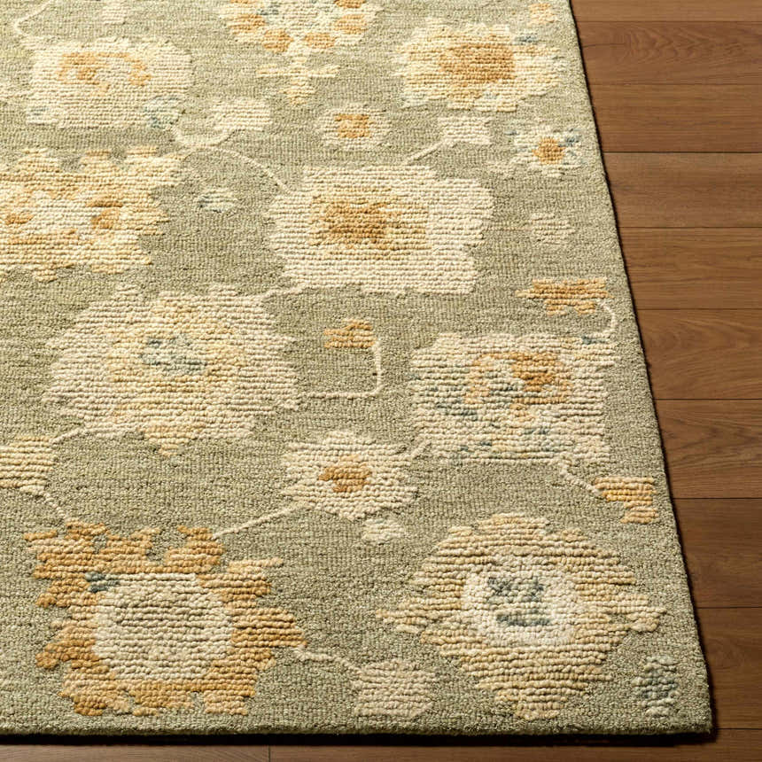 Close-up of the hand-tufted Rihuce Traditional Handmade Area Rug. Cream, pale pink, sage, and sky blue floral pattern. 100% wool. Front