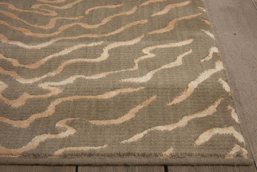 Close up of the Quartz Nourison Nepal vintage rug featuring a wavy beige pattern on a neutral background.