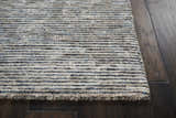 Close up of the taupe Nourison Ellora Slate rug showing the striped pattern and textured, handmade construction.
