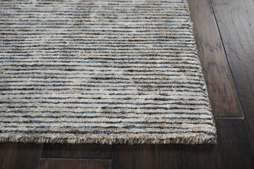 Close up of the taupe Nourison Ellora Slate rug showing the striped pattern and textured, handmade construction.