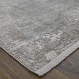 Close-up of the Feizy Cadiz rug. Modern abstract design in taupe, gray, and silver with a subtle fringe. Corner