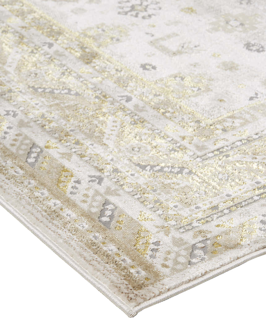 Close-up of Feizy Aura Modern Persian rug. Gold and ivory tones, vintage-inspired pattern, soft texture. Corner