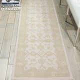 Hallway scene with Nourison Zephyr Ivory/Green runner rug, floral pattern, on light hardwood floor with white bench.